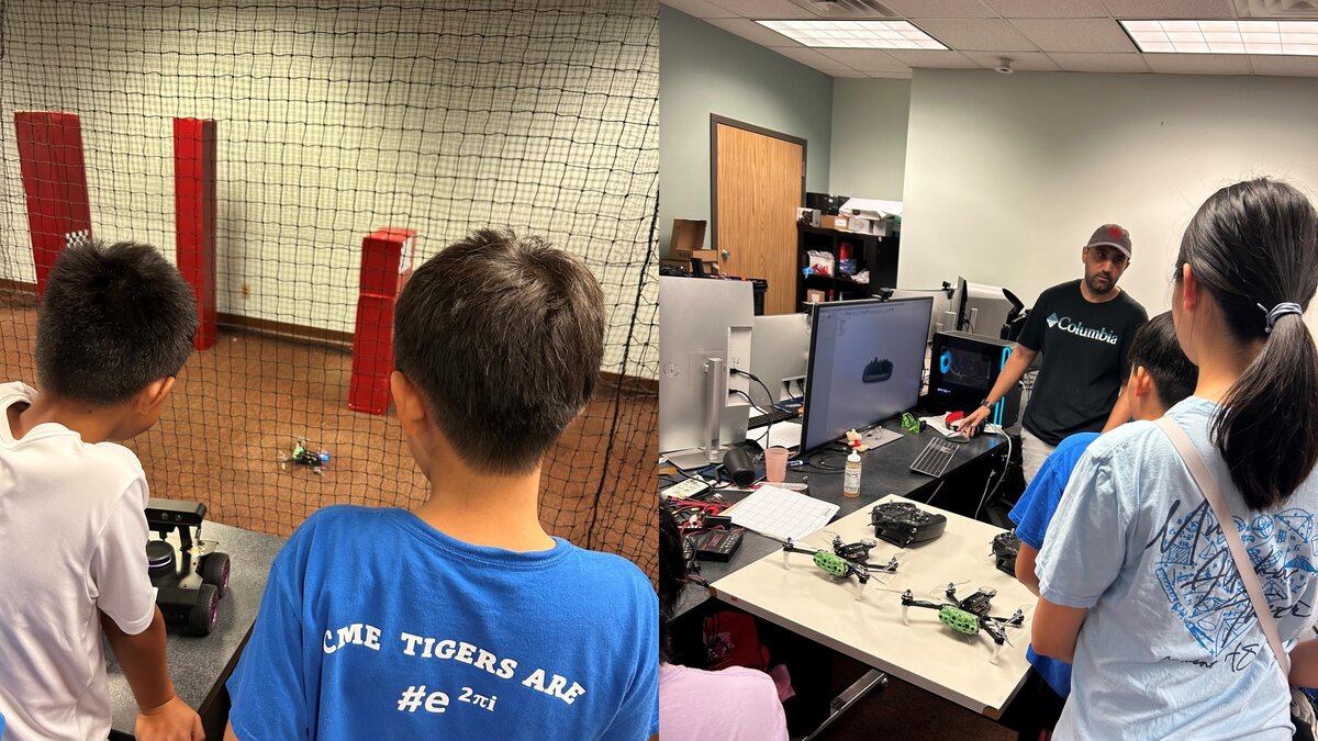 Young students watching robots in the NAIL Lab testing arena.